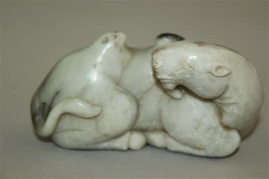 A Chinese white and black jade carving of a recumbent Bactrian camel, in Song dynasty style, 8.5cm